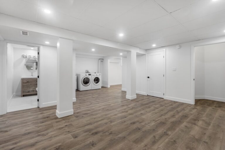 Bright finished basement with clean walls and flooring