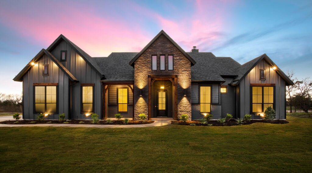 Residential home with a shingle roof at dusk