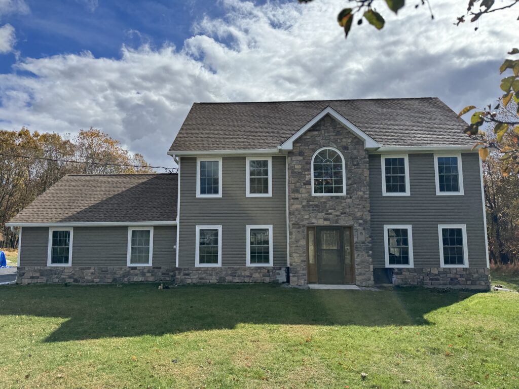 House with horizontal siding and stone exterior surfaces